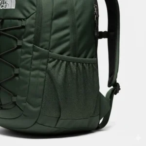 Close-up of the mesh side water bottle pocket on the dark green north face backpack.