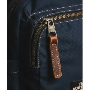 Illustration 3: Detail of the durable metal YKK zippers on a rugged vintage north face backpack.