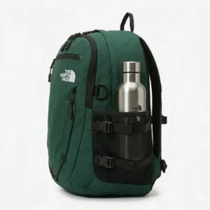Side profile showing the water bottle pocket of a green the north face backpack.