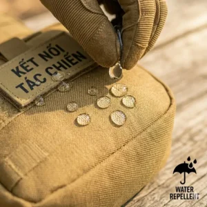 A test shot showing water beads rolling off the rugged, water-resistant material of a black tactical sling bag.