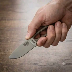 A hand demonstrating a secure forward grip on a textured handle of a compact fixed blade edc knife.