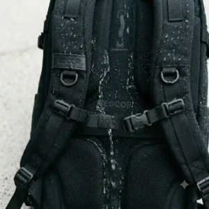 Water droplets shedding off the water-resistant fabric of a durable edc carry backpack during a light rain.