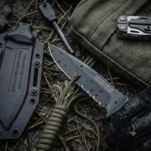 Serrated armed force tactical knife cutting heavy-duty paracord during survival field testing.